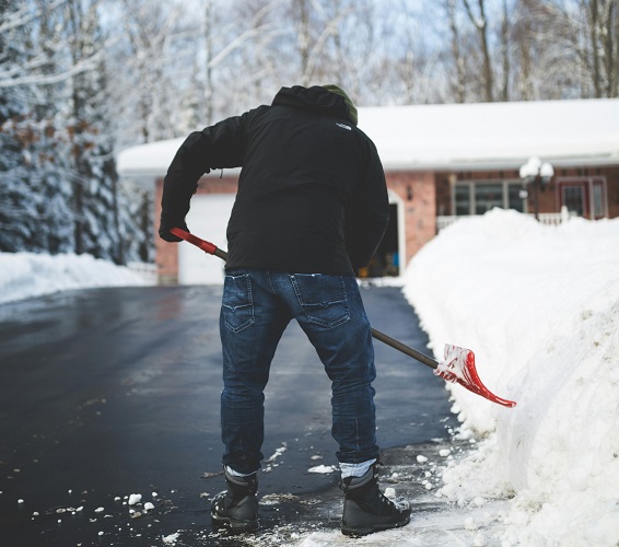 Mann schippt Schnee