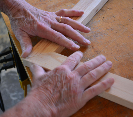 Holz-Bearbeitung: Hände, die zwei Leisten verbinden