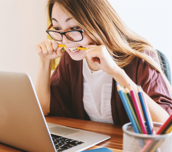 Stress vermeiden: Person vorm PC, die auf einen Stift beisst